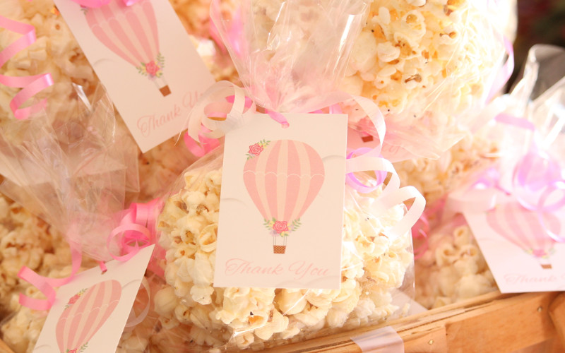 Pink Hot Air Balloon favor tags on bags of gourmet popcorn.
